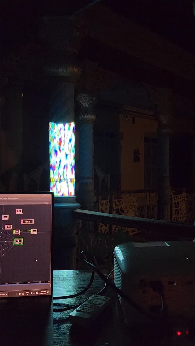 Generative colour projected onto a pillar of a Chettinad mansion, a projector and a laptop running TouchDesigner in the foreground